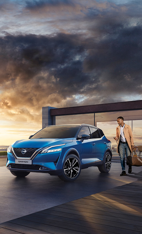Blue Qashqai in front of building with driver approaching